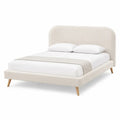 Cama tapizada doble beige con patas de madera